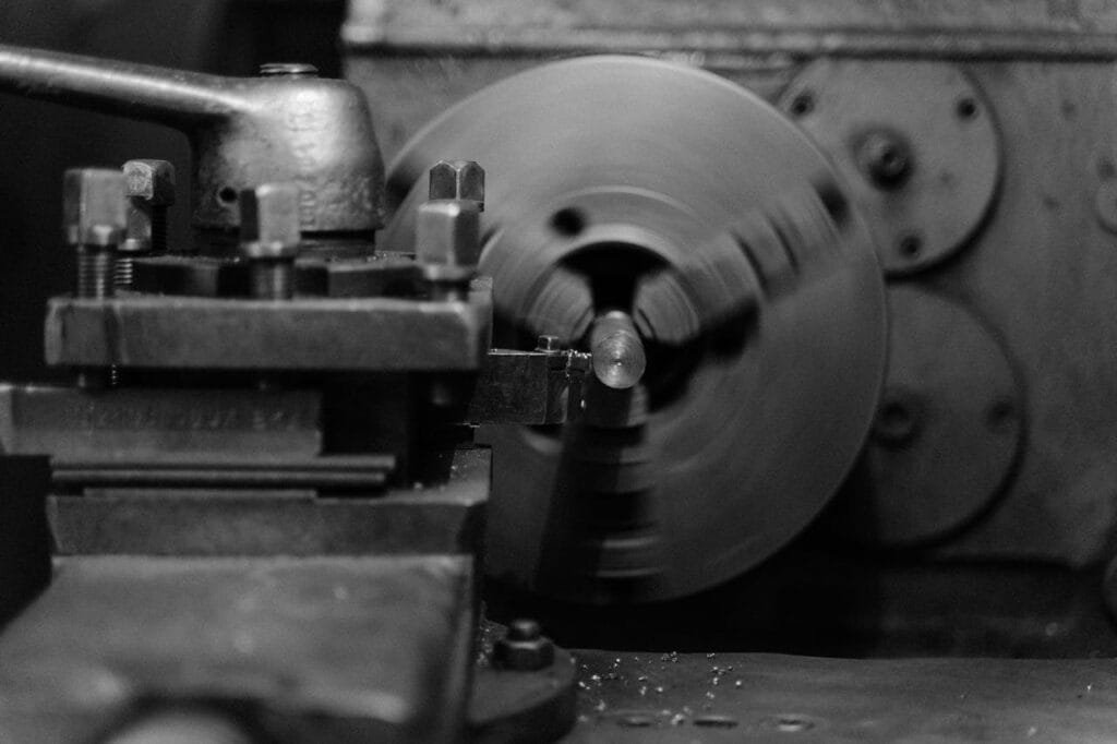 pexels-photo-5846176 Black and white close-up of an industrial lathe machine showing its intricate mechanical details.